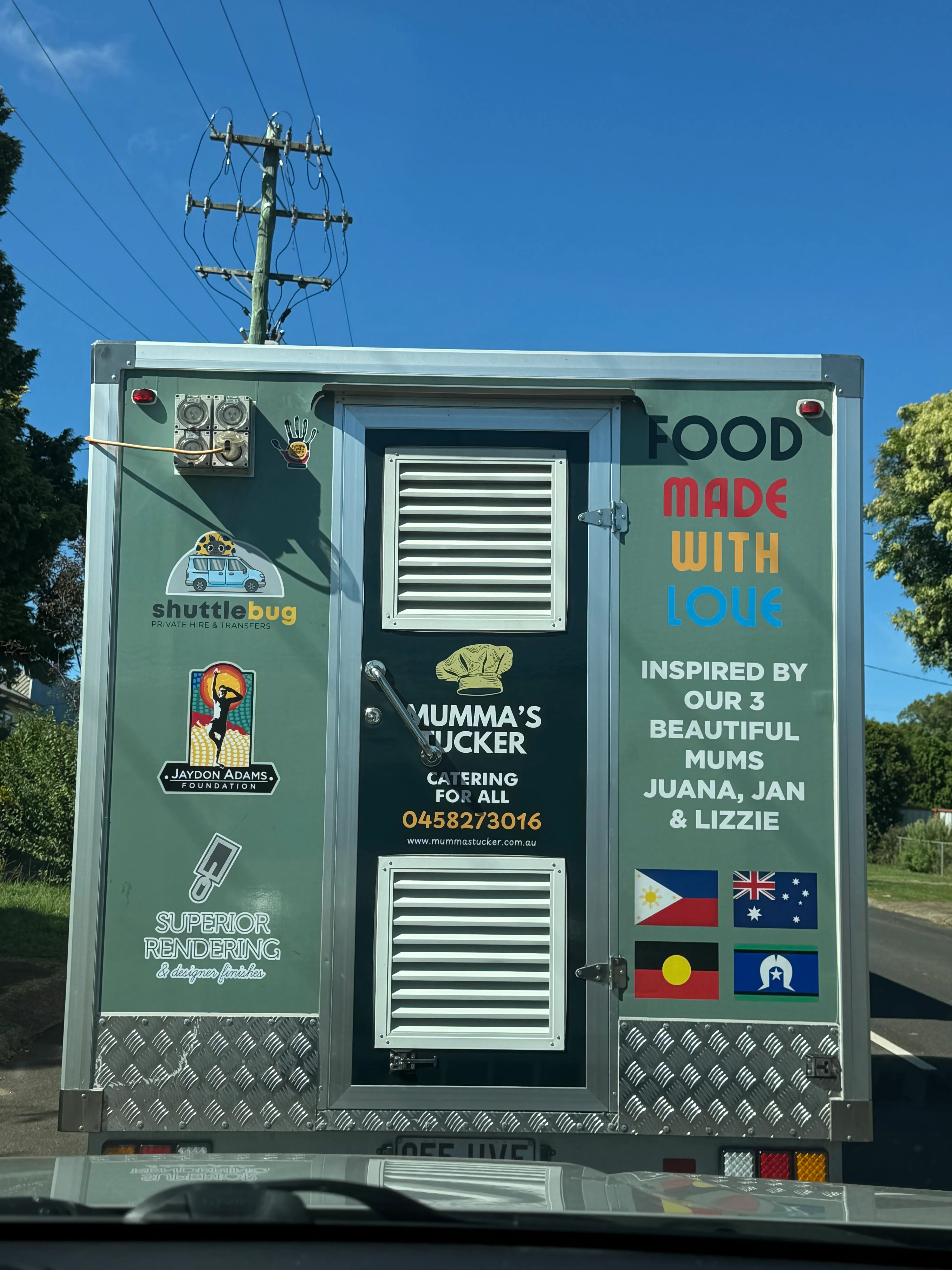 Close-up of the Mumma's Tucker food trailer rear panel branding
