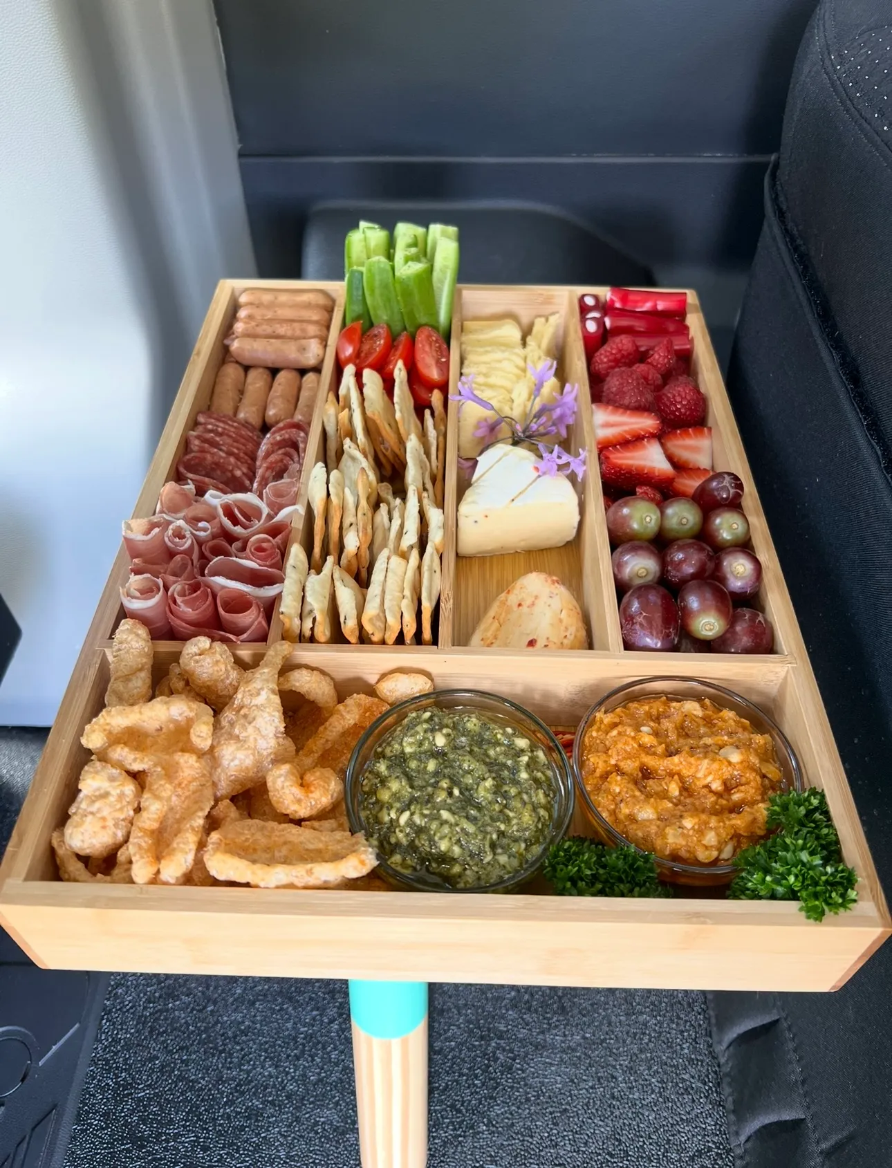 Individual bamboo grazing box with meats, cheese, berries and dips