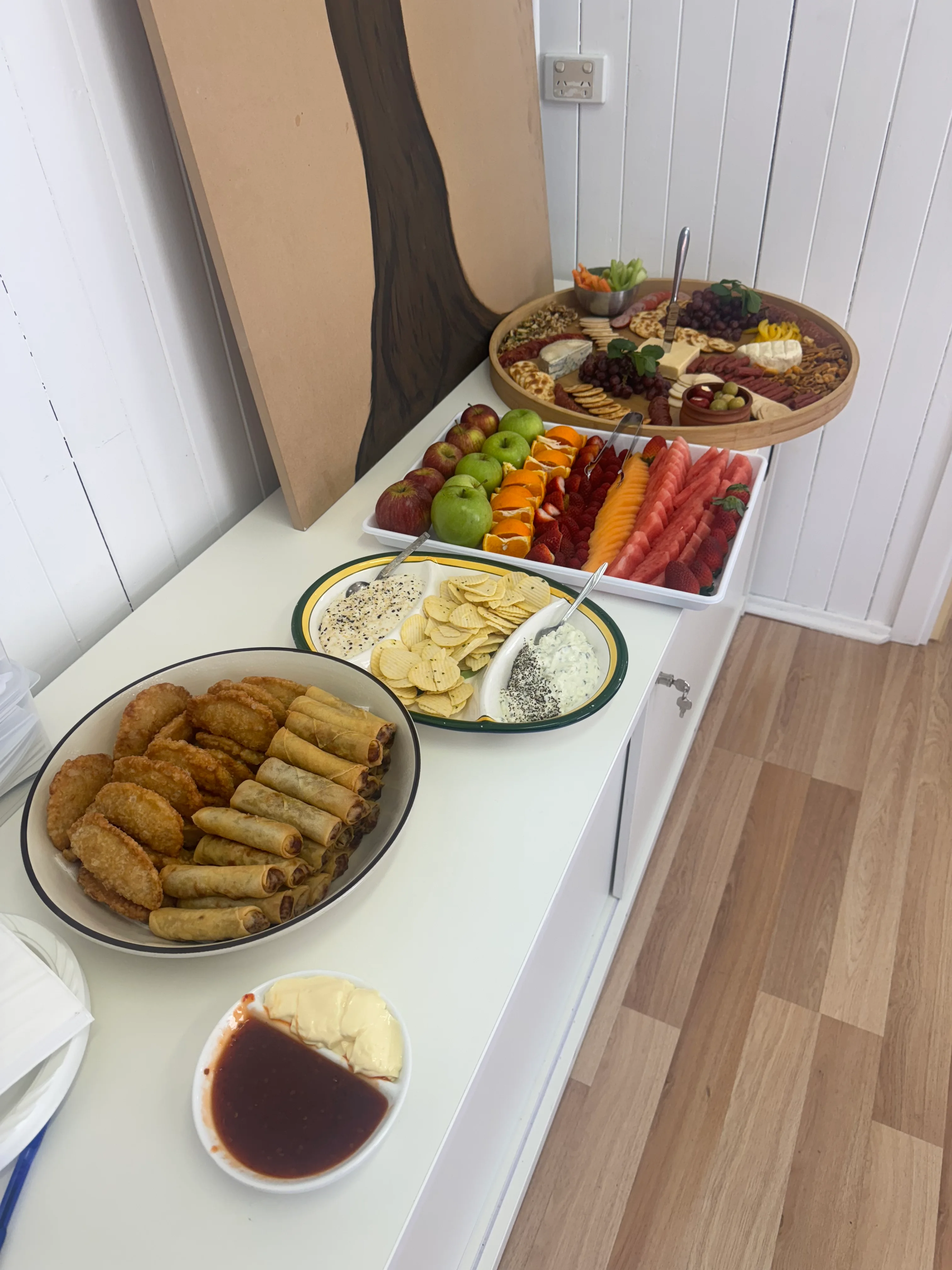 Catering setup detail — boards and finger food being arranged at the Mumma's Tucker pass.